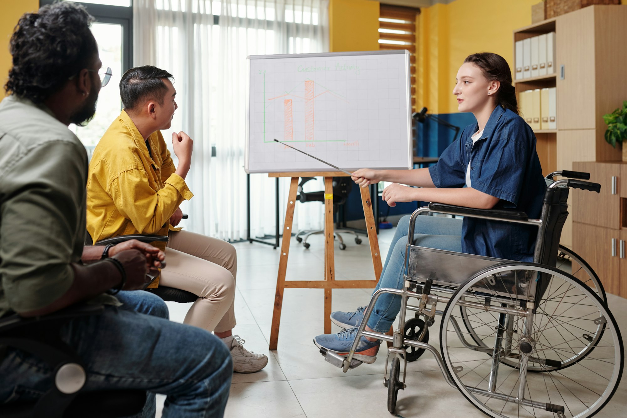 Businesswoman with Disability Pointing at Chart