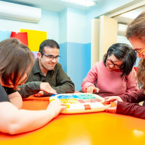 Group of disabled people playing board games together