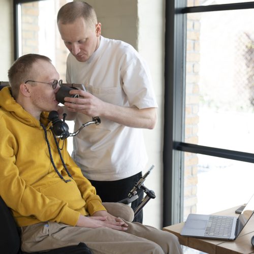 medium-shot-friend-helping-disabled-man
